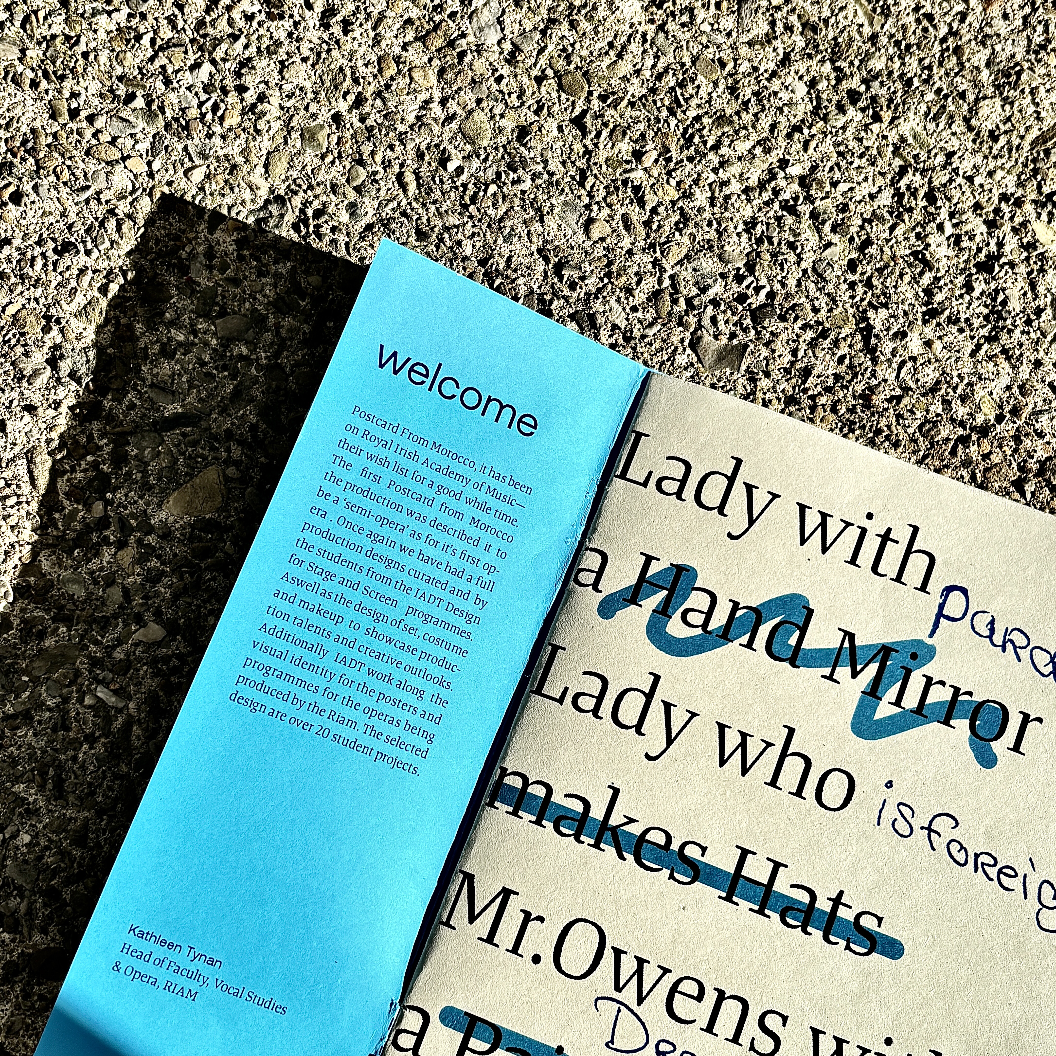 Programme spread showing typographic list of characters and their possessions, with handwritten annotations layered on top